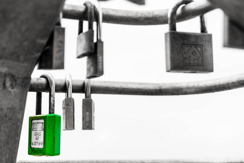 green Masterlock padlock next to other locks
